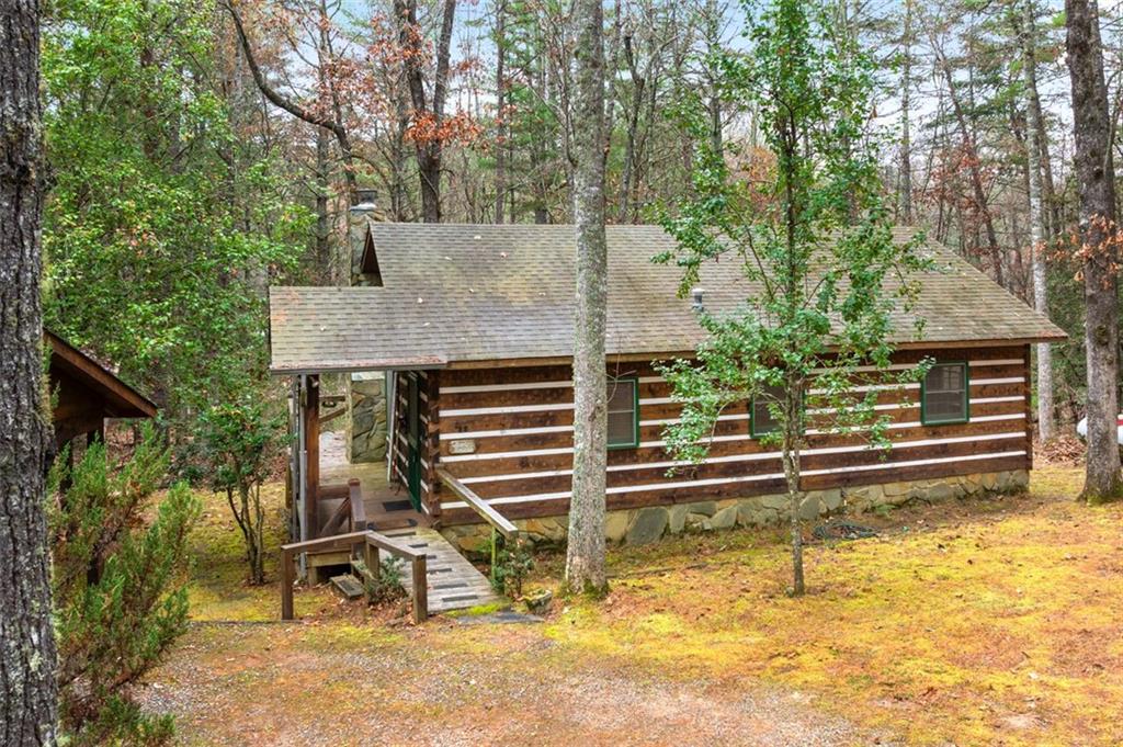 a view of house with backyard and seating area