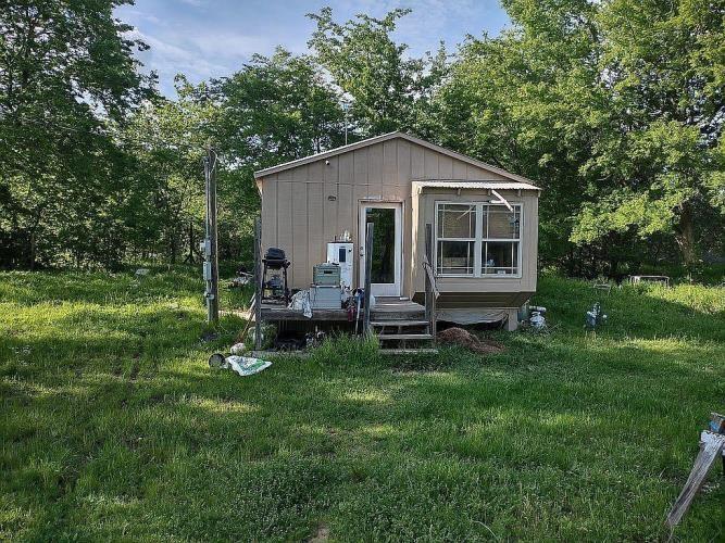 a view of a house with a yard and sitting area