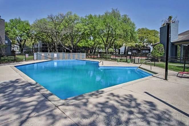 a view of a swimming pool with an outdoor seating