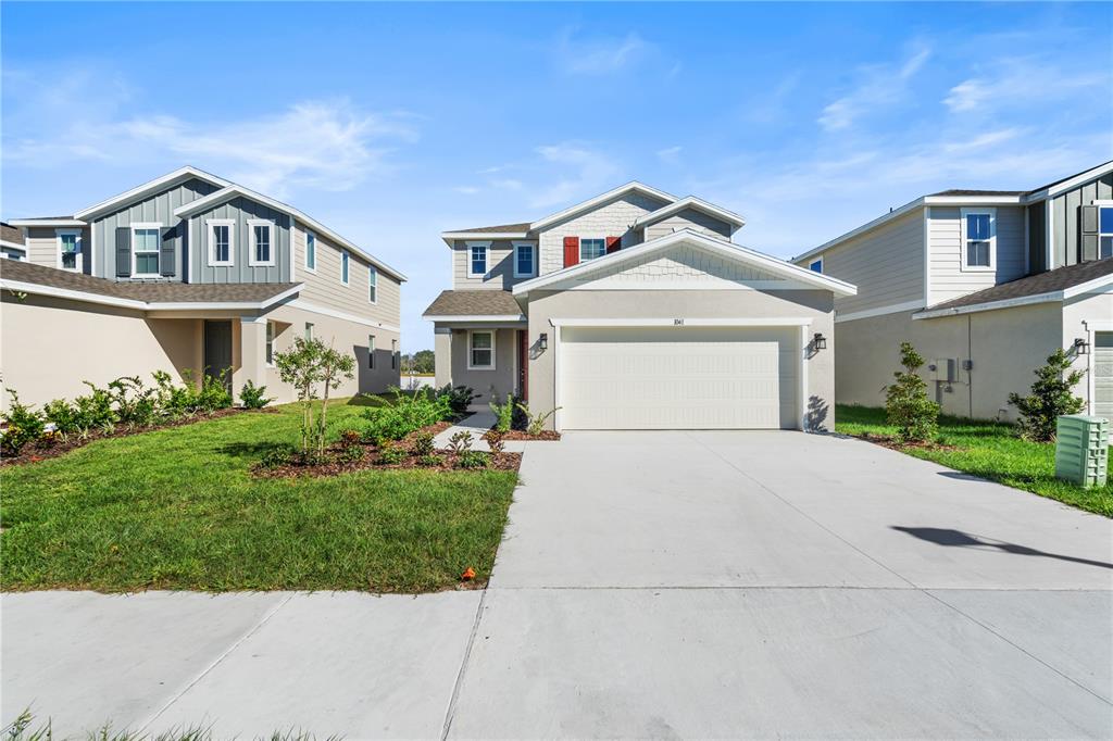 a front view of a house with a yard and garage