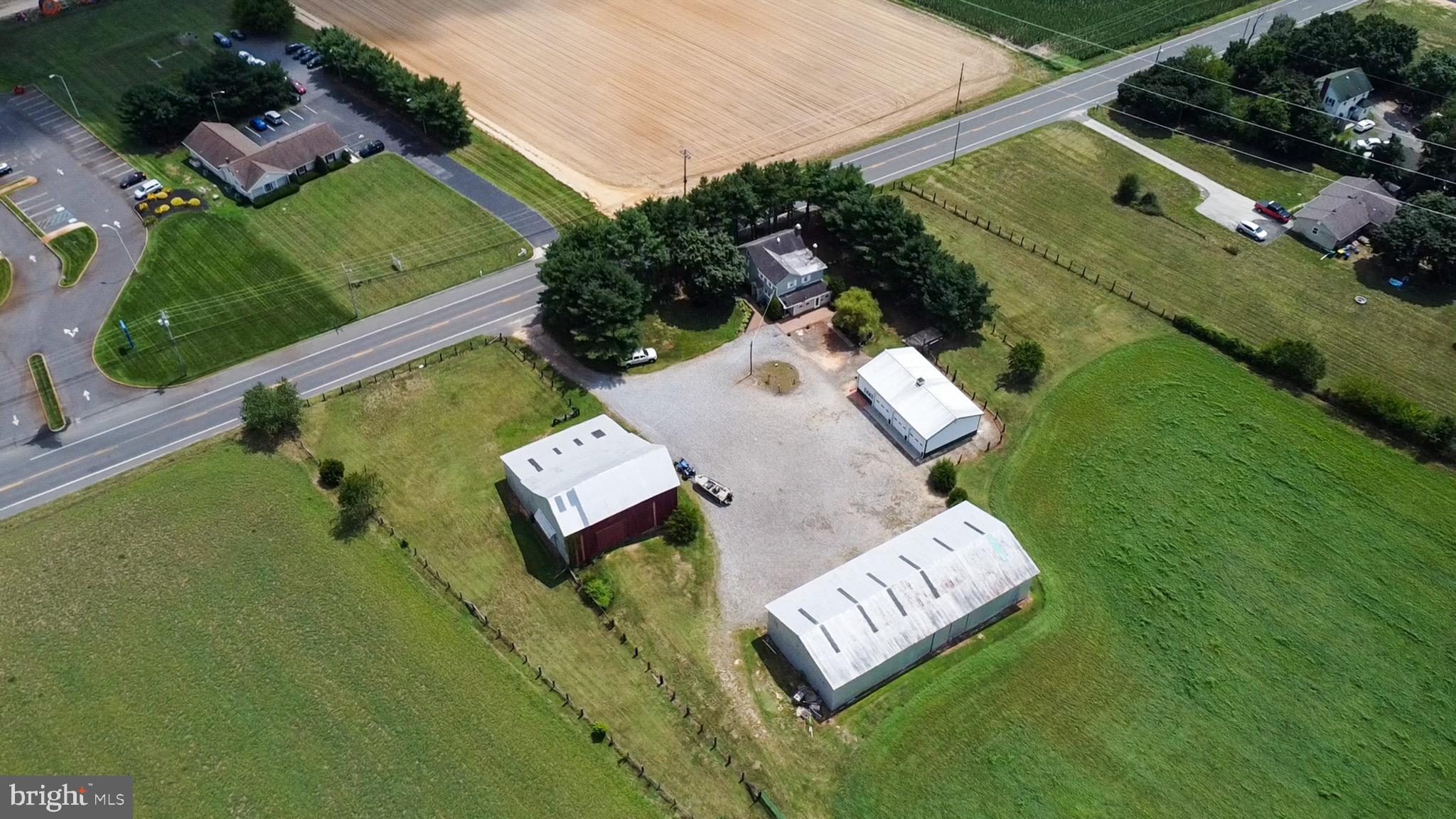 an aerial view of a house with garden space and street view