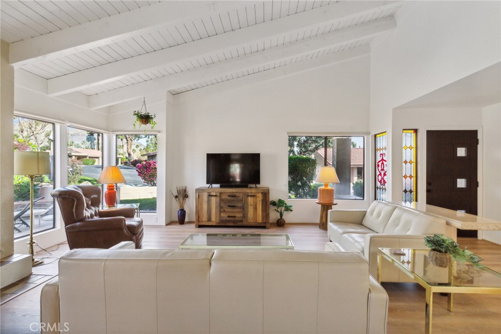 a living room with fireplace furniture and a flat screen tv