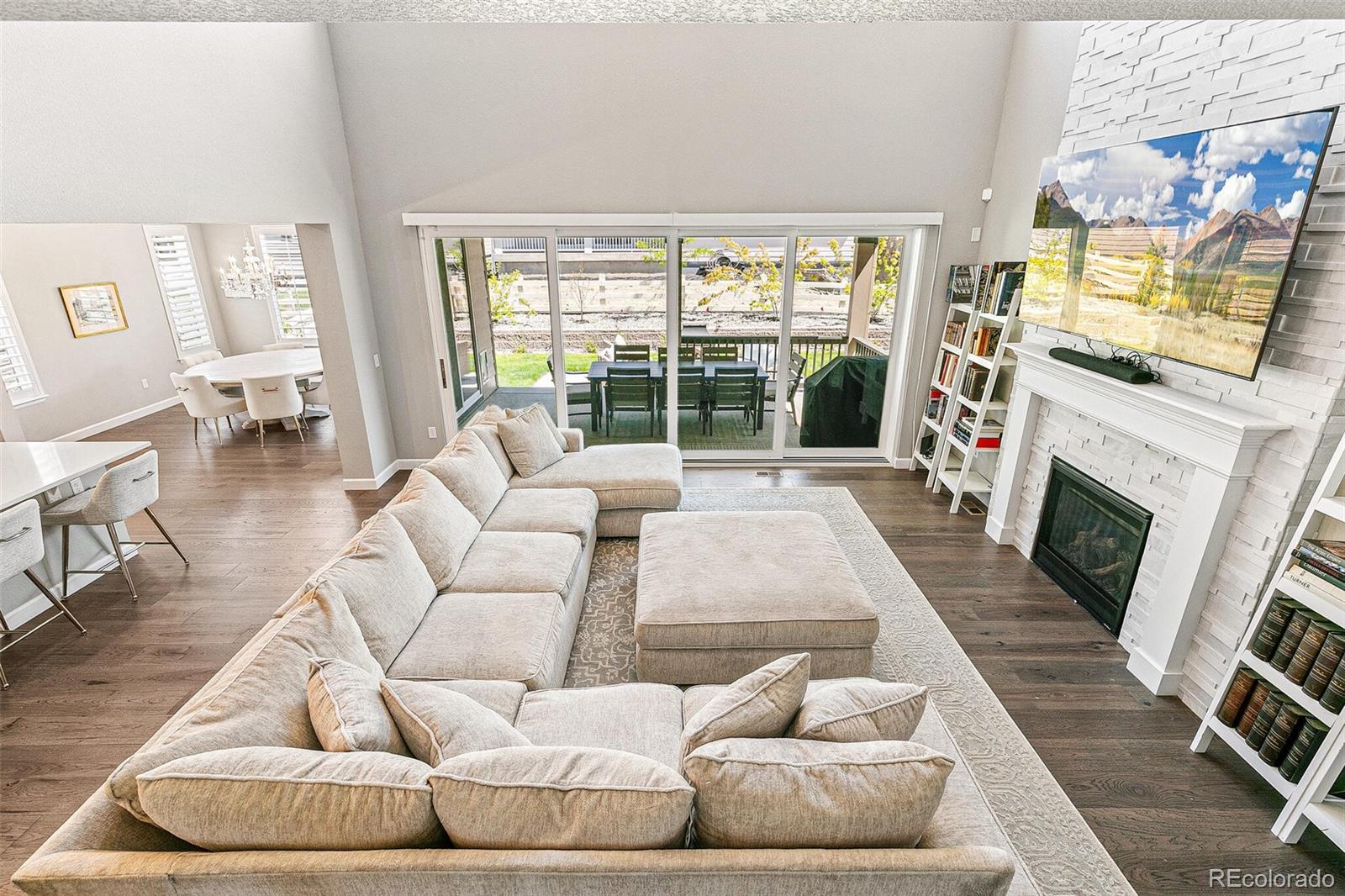 a living room with furniture large window and a fireplace