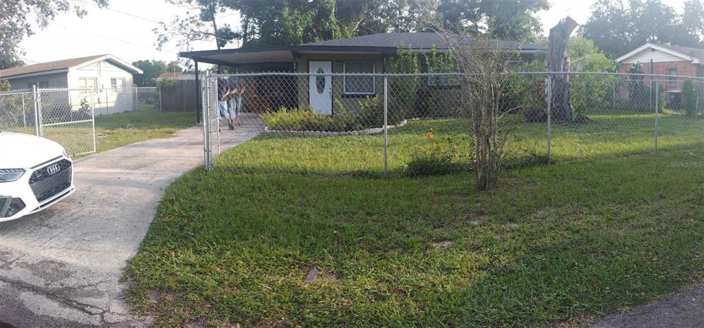 a view of a house with a backyard and porch