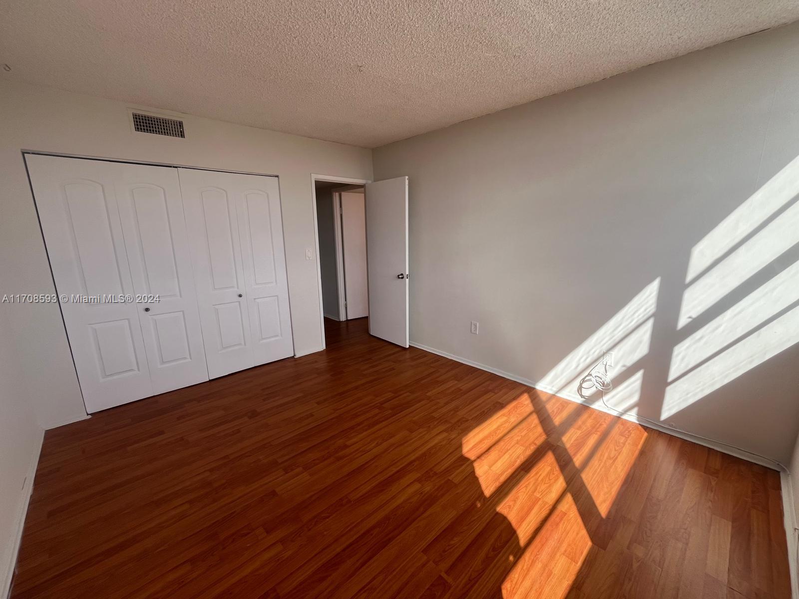 a view of a room with wooden floor and stairs