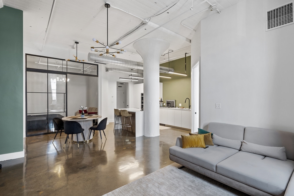 a living room with furniture a dining table and chairs