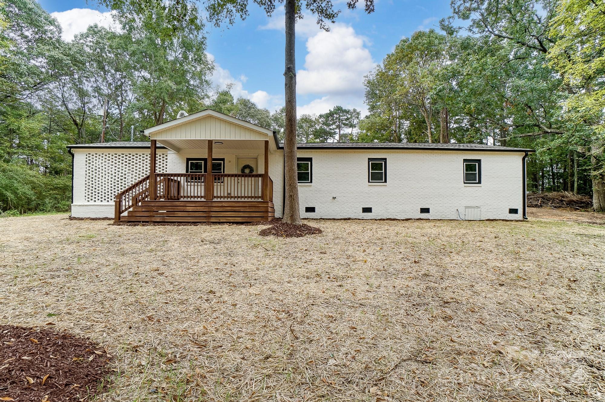 a front view of a house with wooden fence