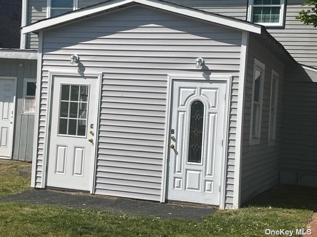 a view of a house with a door and a large window