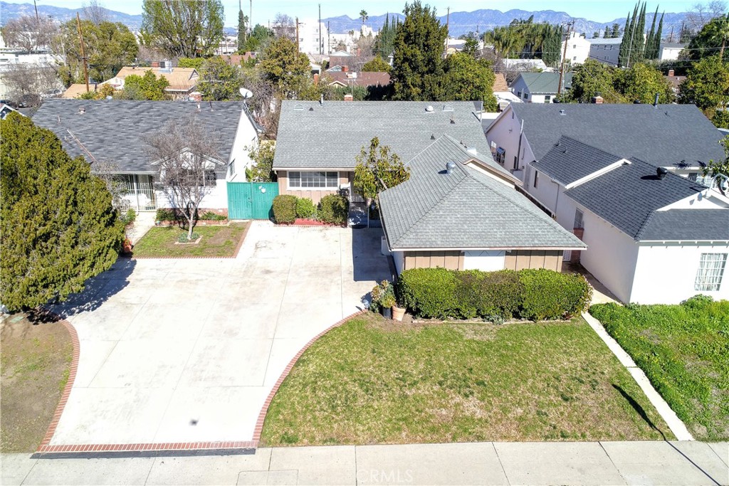 an aerial view of a house with a yard and trees