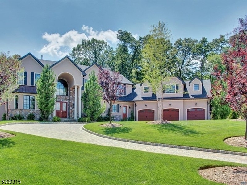 a front view of a house with a garden and plants