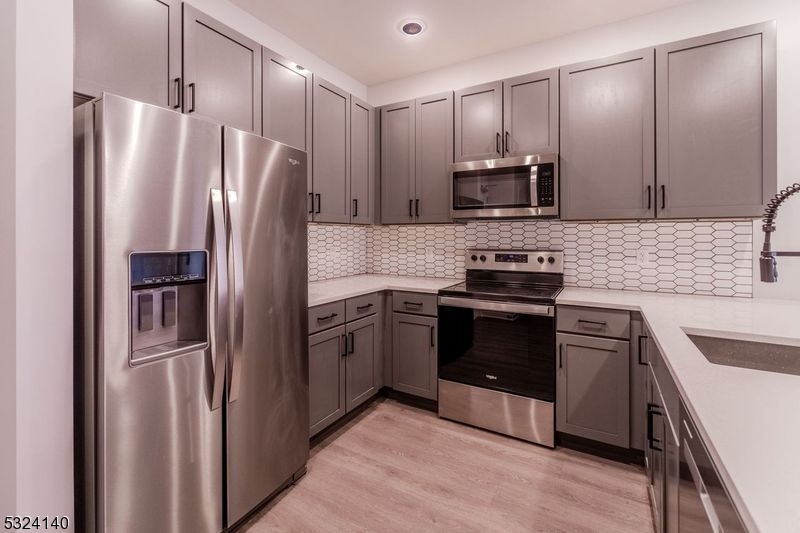 a kitchen with stainless steel appliances and wooden cabinets