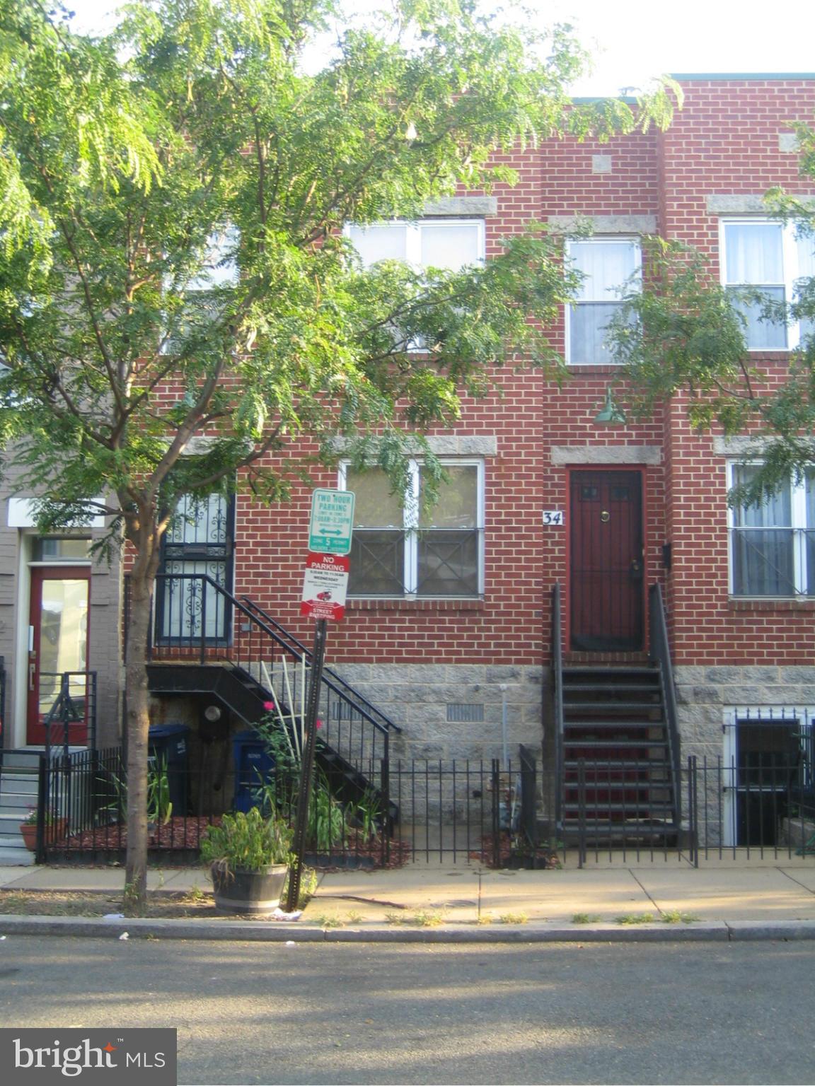 a view of a brick building next to a yard