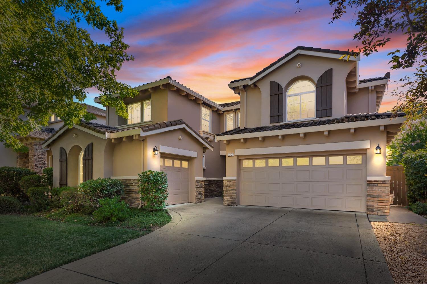 a front view of a house with a yard and garage