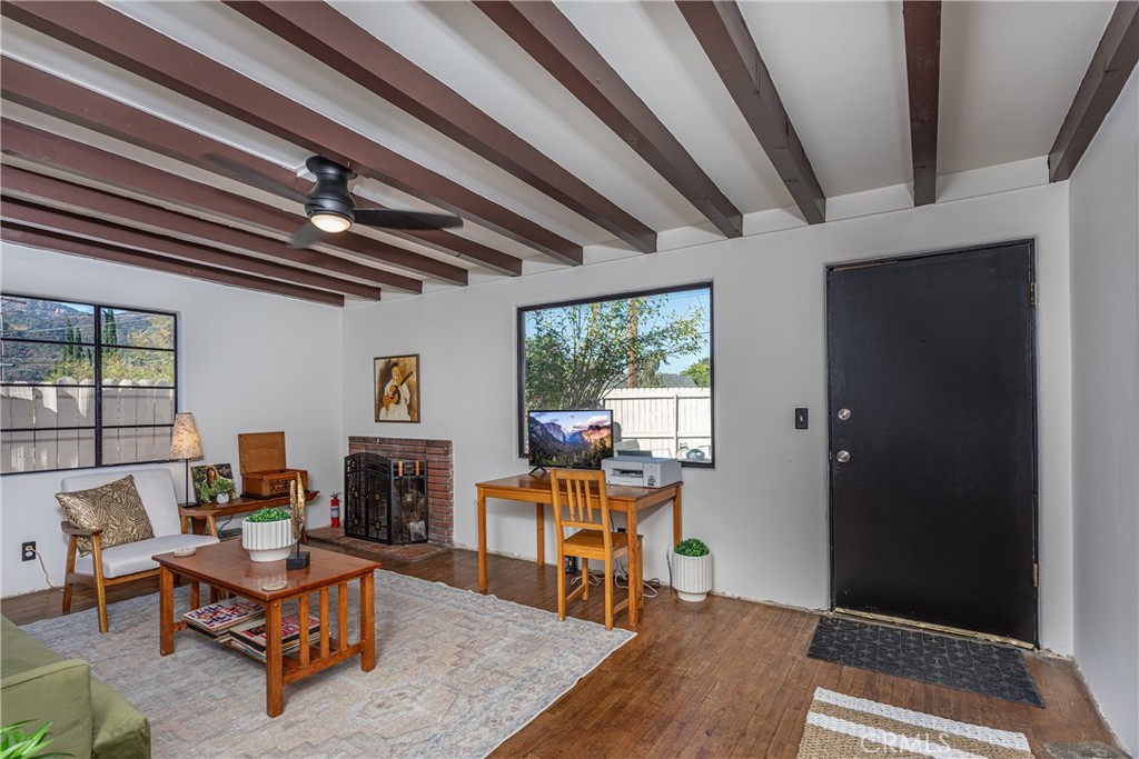 a living room with furniture a rug and a fireplace