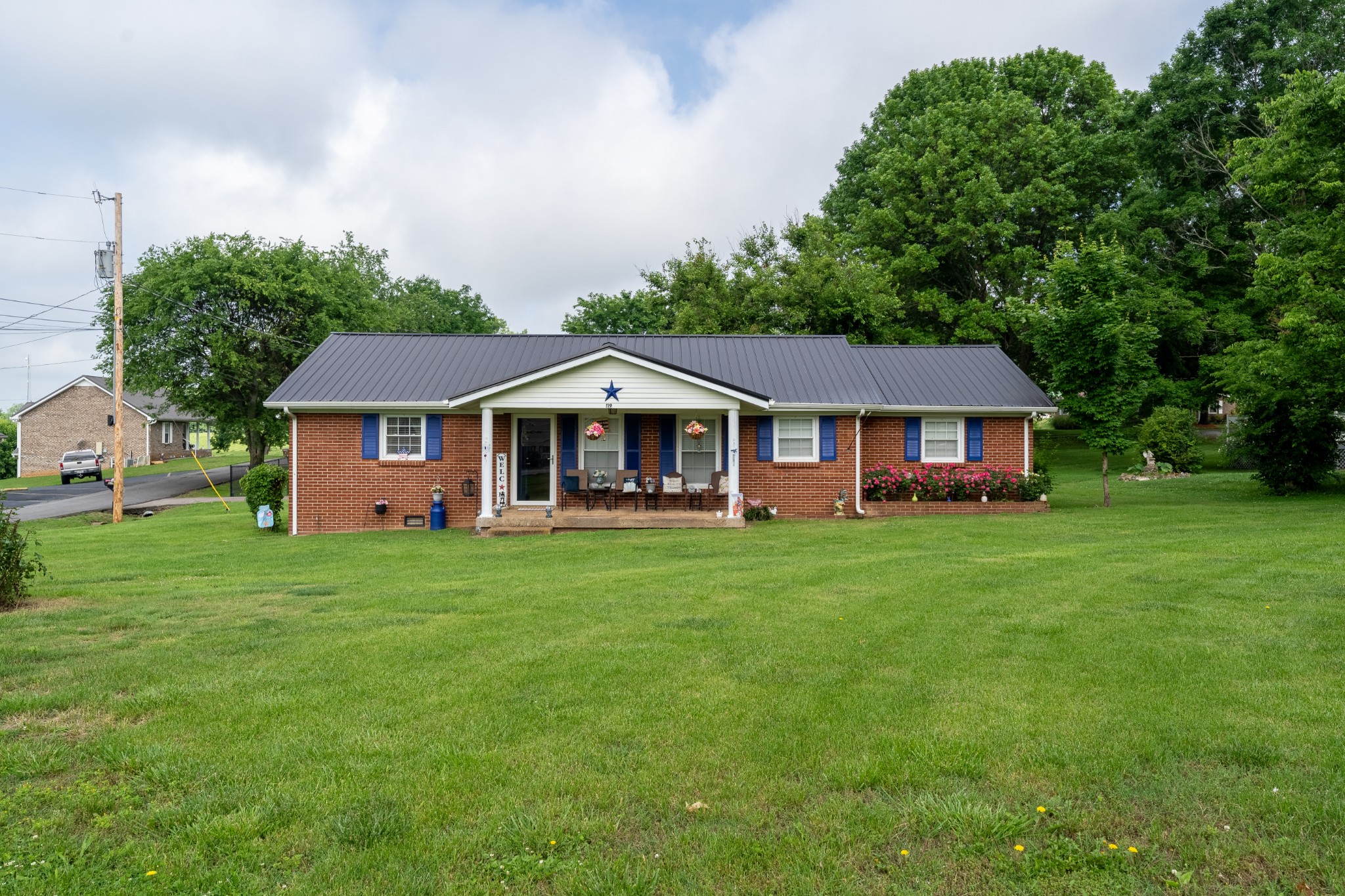 a front view of a house with yard and green space