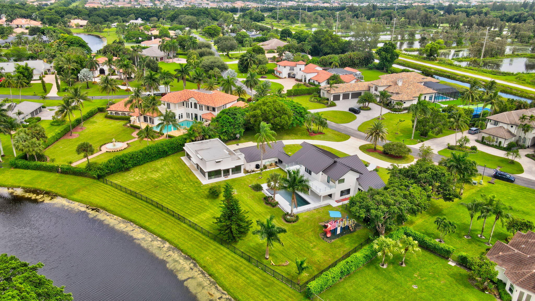 an aerial view of residential houses with outdoor space and river view