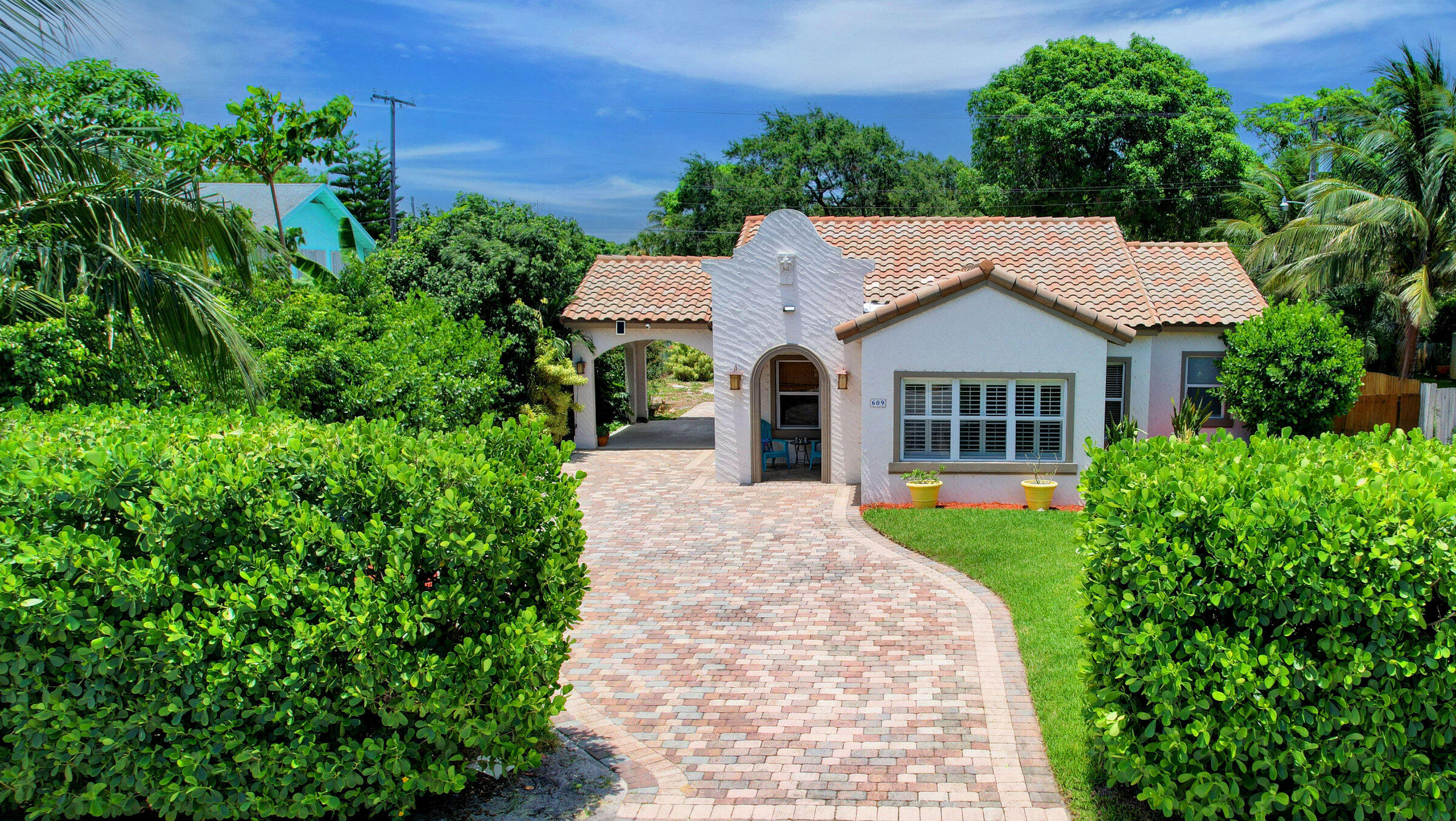 a aerial view of a house with a yard and potted plants