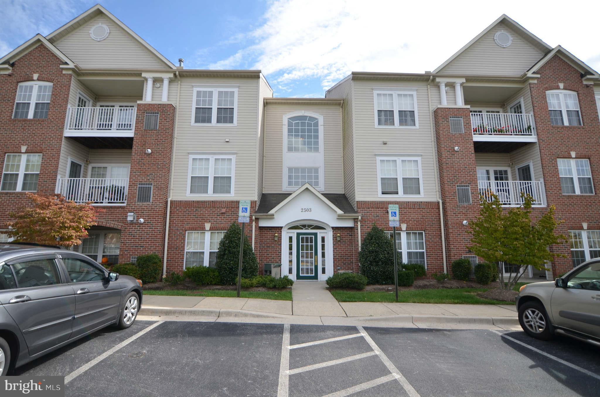 a front view of a residential apartment building with a yard