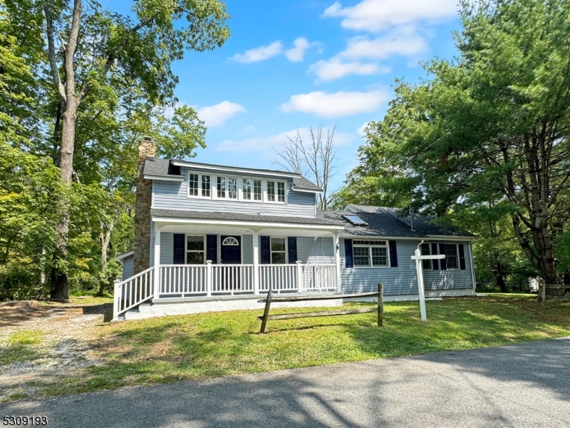 a front view of a house with swimming pool and porch