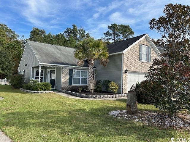 View of front of house with a garage and a front l