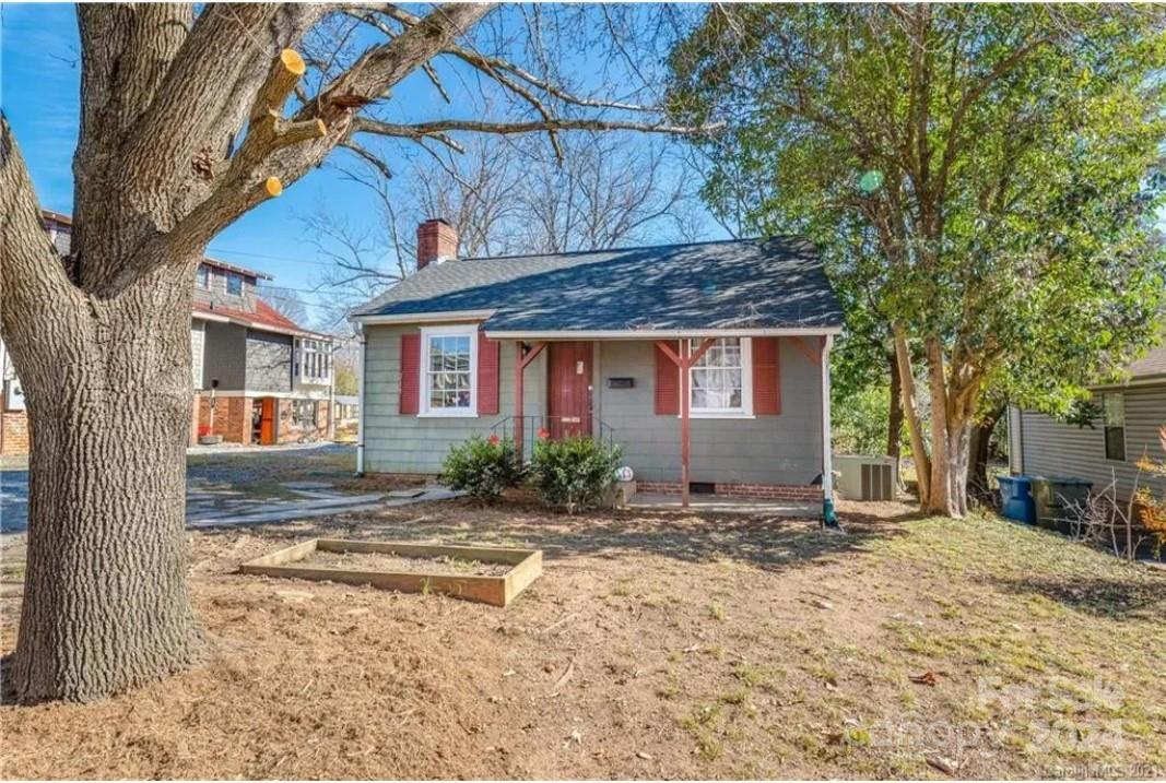 a view of a house with a tree in the background