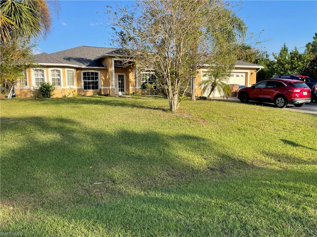 Single story home with a front lawn and a garage