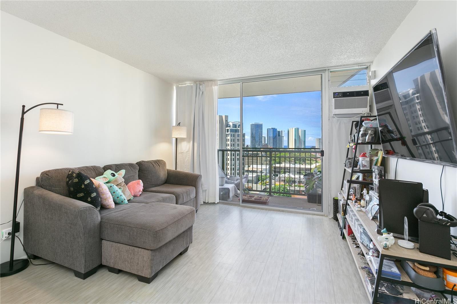 a living room with furniture floor to ceiling window and floor to ceiling window