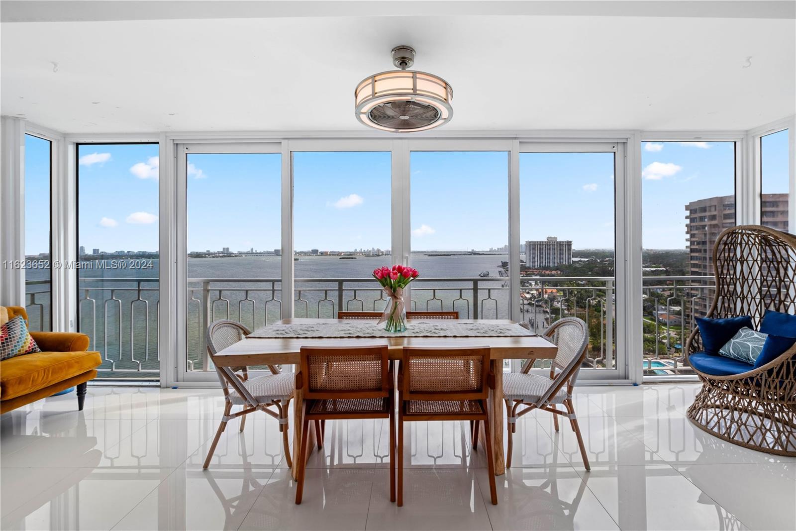 a dining room with furniture a chandelier and a rug