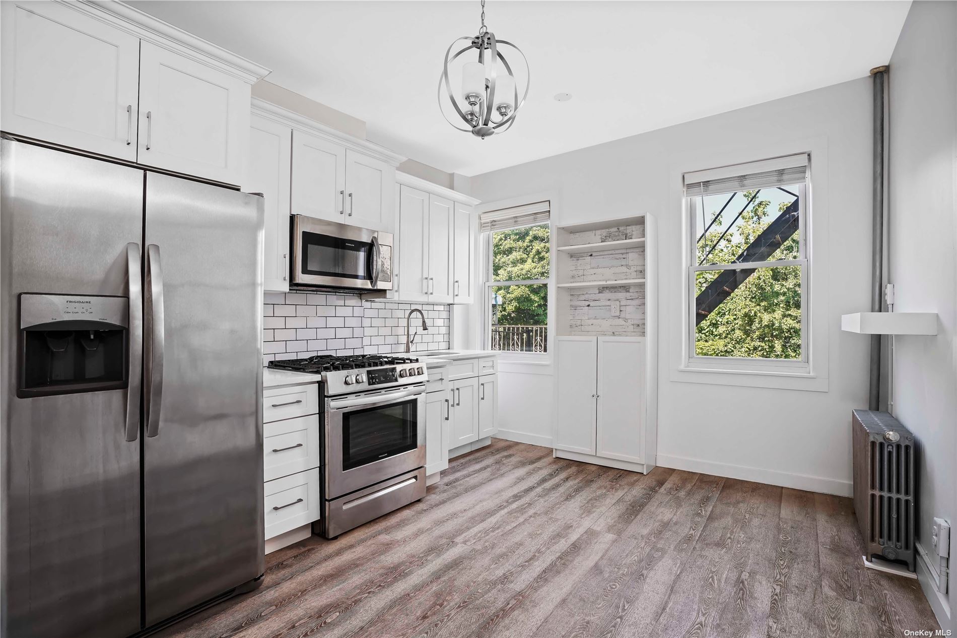 a kitchen with stainless steel appliances a refrigerator sink and stove