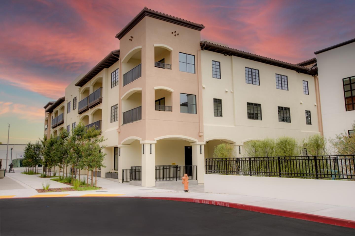 a front view of multi story residential apartment building with garage