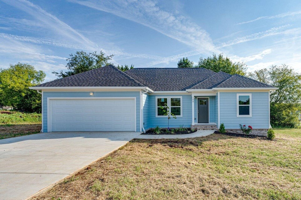 a front view of a house with a yard