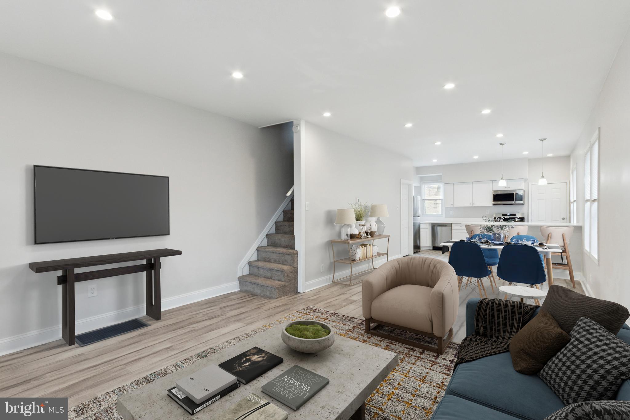 a living room with furniture a flat screen tv and a fireplace