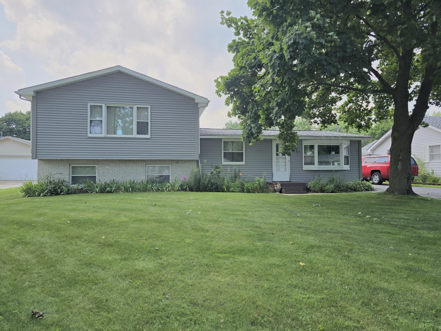 a front view of house with yard and green space