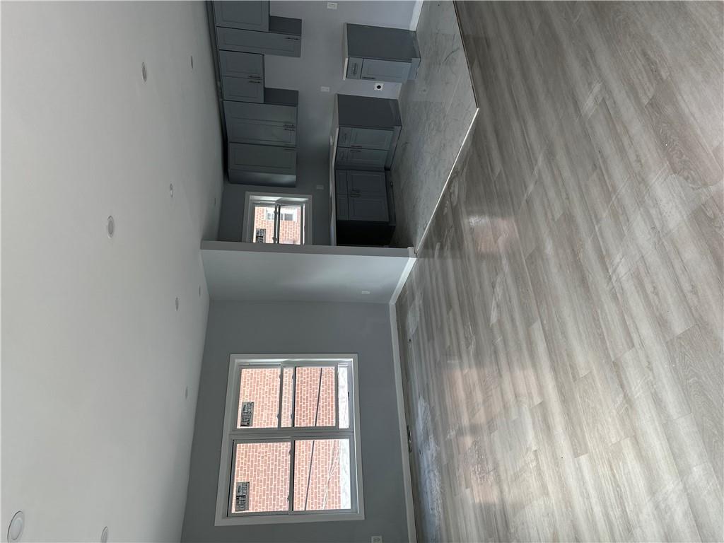 Unfurnished living room with light wood-type flooring