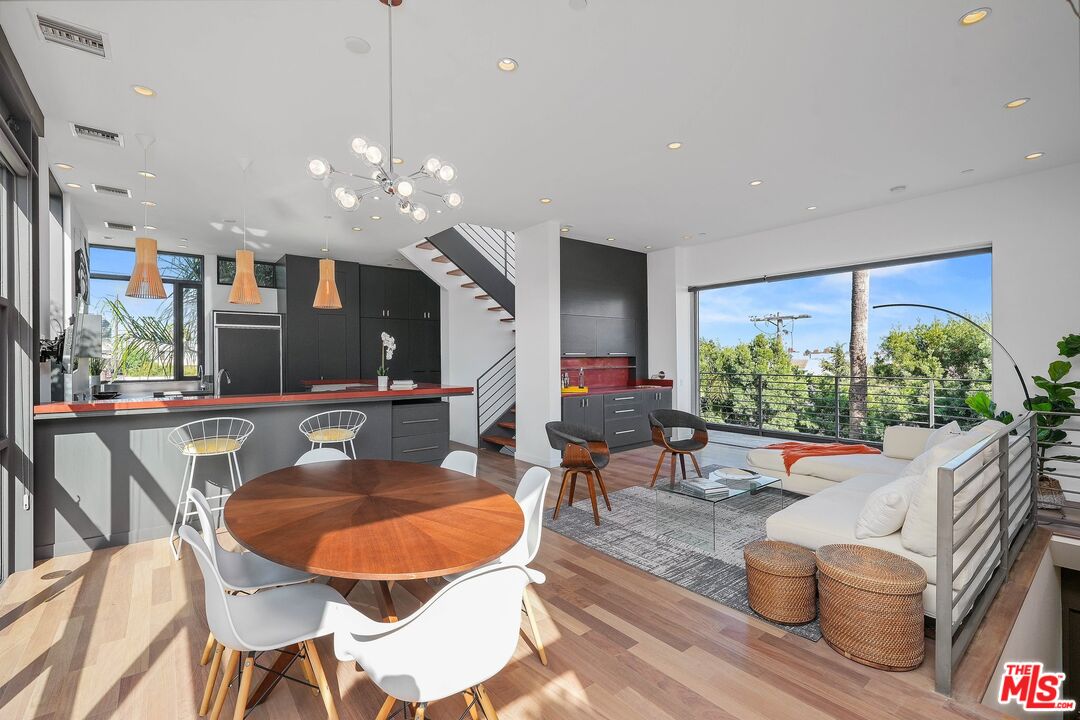 a living room with furniture a window and a flat screen tv