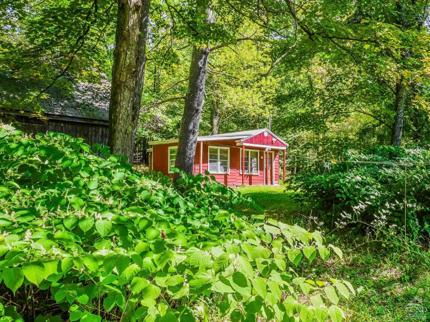 a view of a house with a yard and sitting area