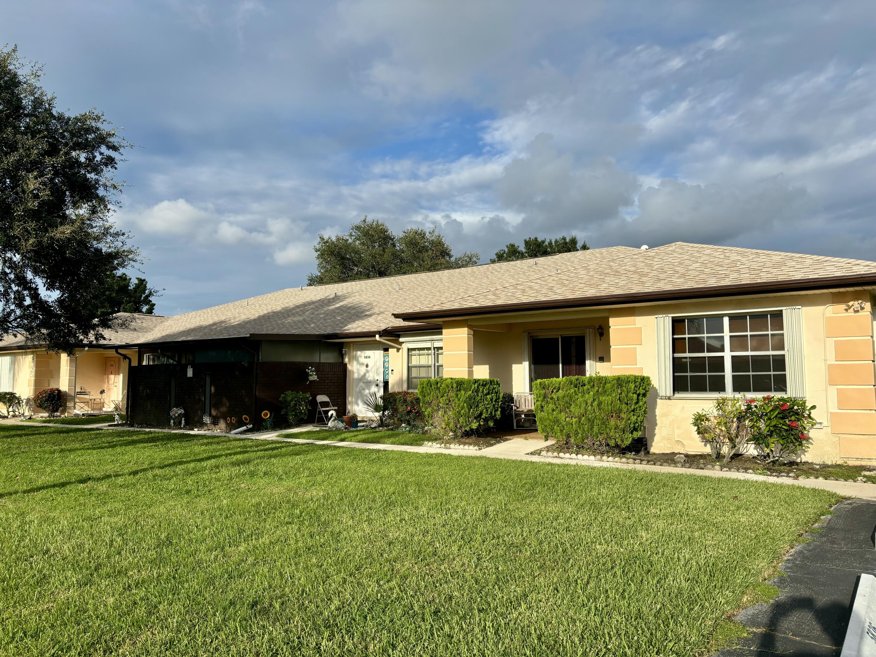 a front view of house with yard and green space