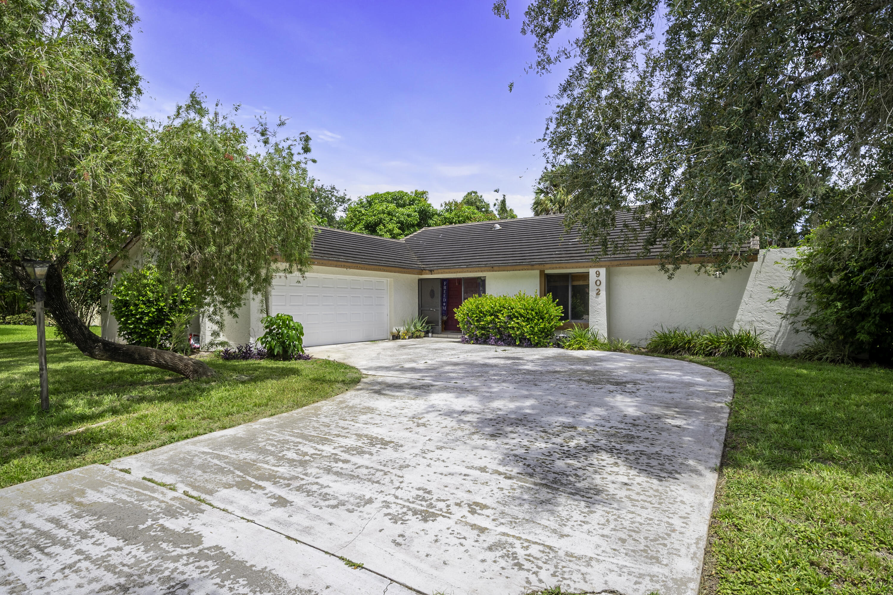 a front view of a house with a yard and a garage