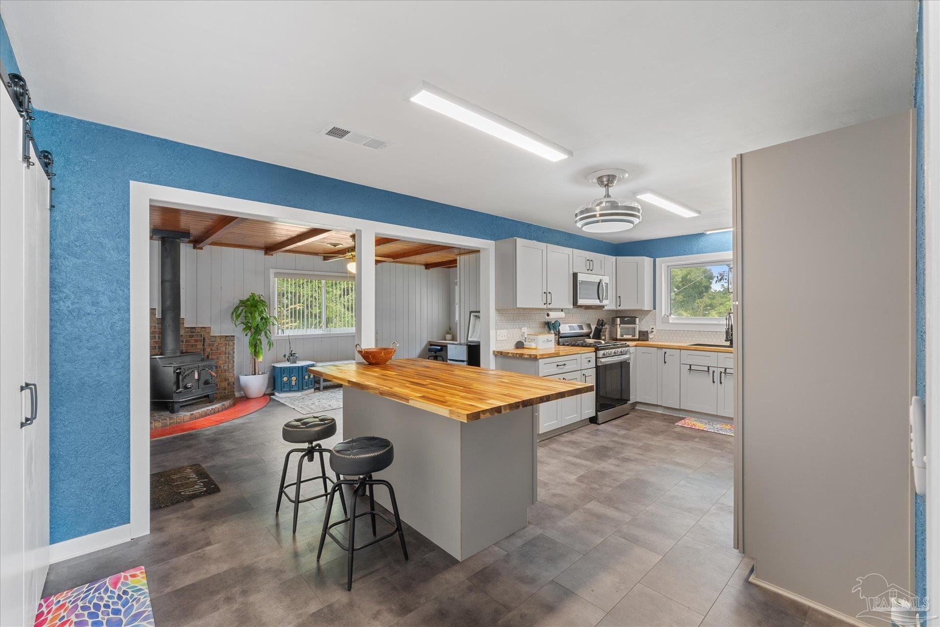 a kitchen with stainless steel appliances kitchen island granite countertop a sink and cabinets