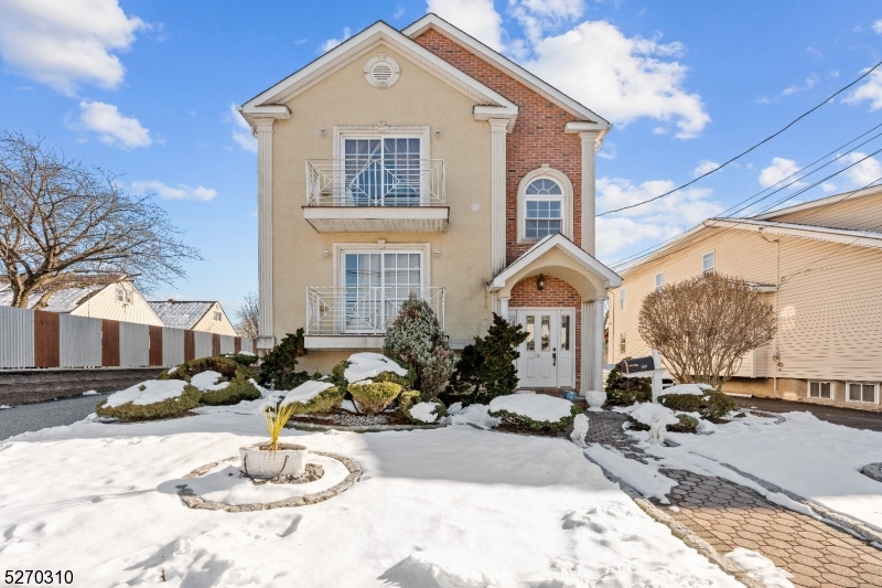 a front view of a house with a yard outdoor seating and covered with snow