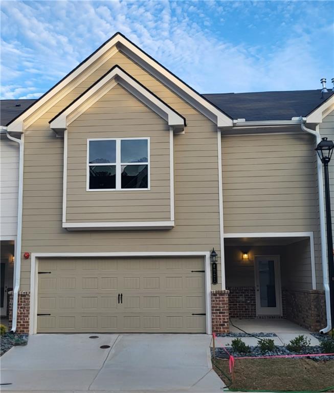 a front view of a house with garage