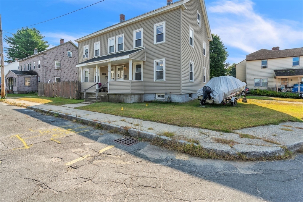 a front view of a house with a garden and plants