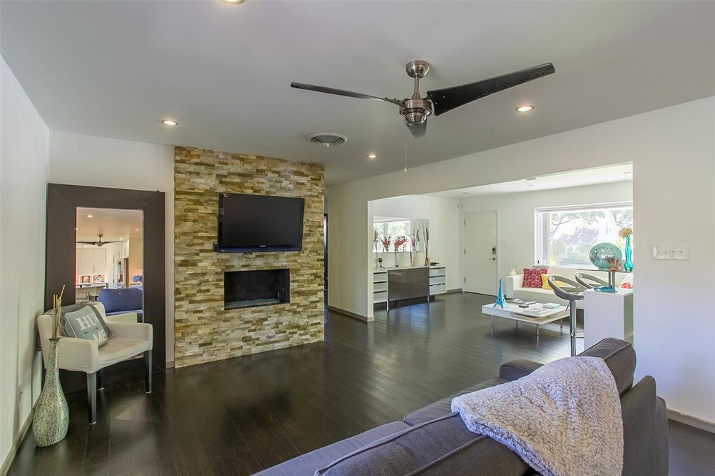 a living room with fireplace furniture and a flat screen tv