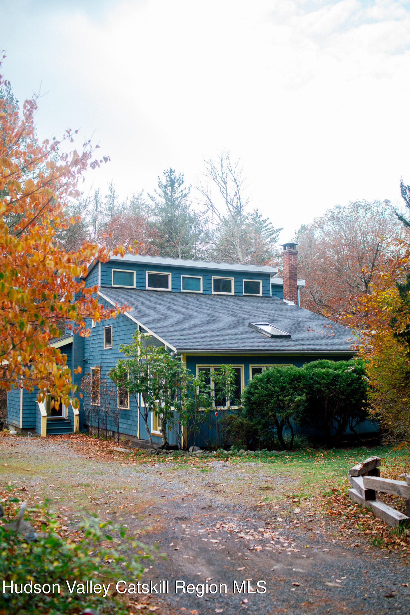 a view of a big house with a big yard and potted plants