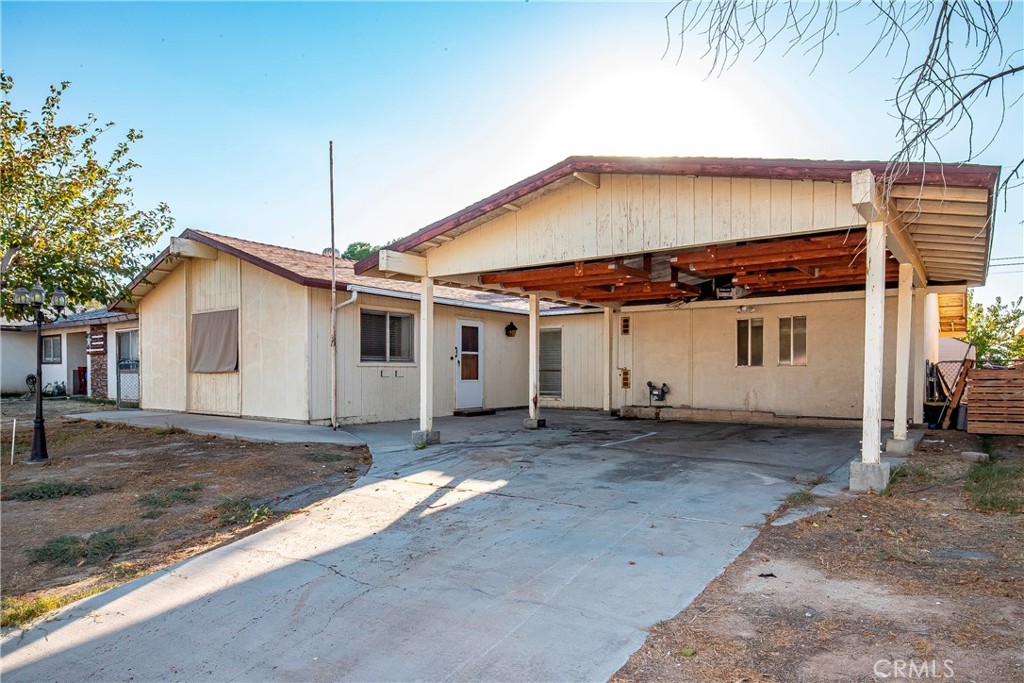 a front view of a house with a large tree