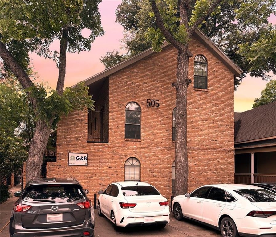 a car parked in front of a brick house