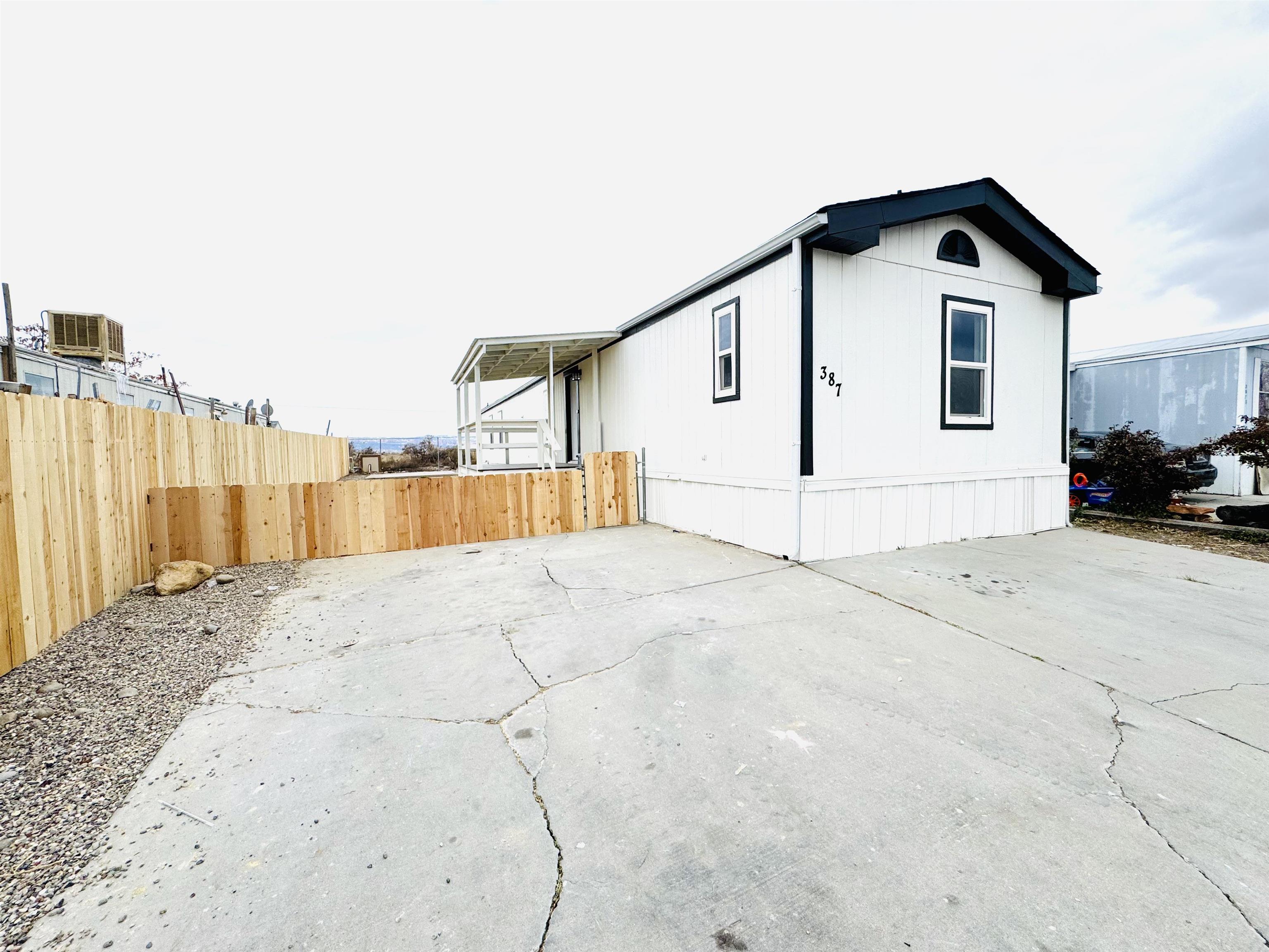 a view of a house with a wooden fence