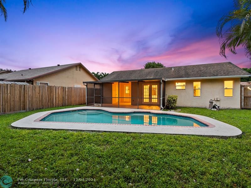 a view of pool with a yard