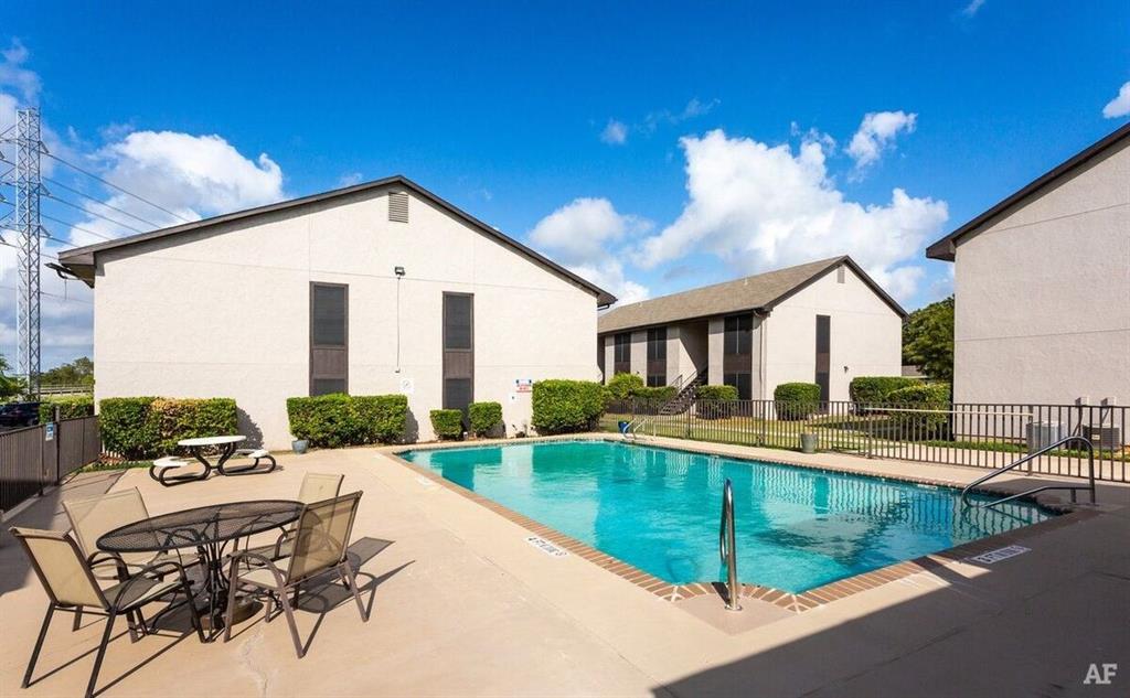 a view of a house with backyard and sitting area