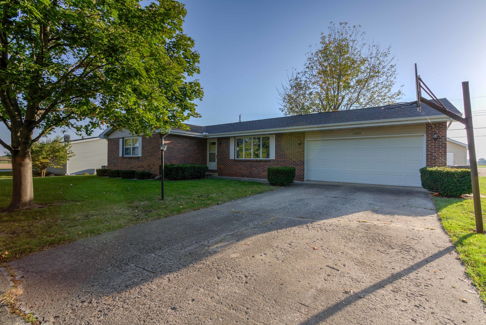 a front view of house with yard and green space